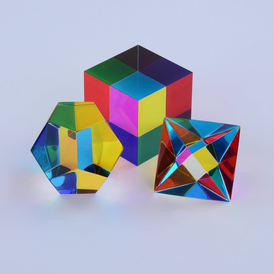 Three translucent CMY Platonic solids in sunlight, showing colours a dog would see as yellow and blue