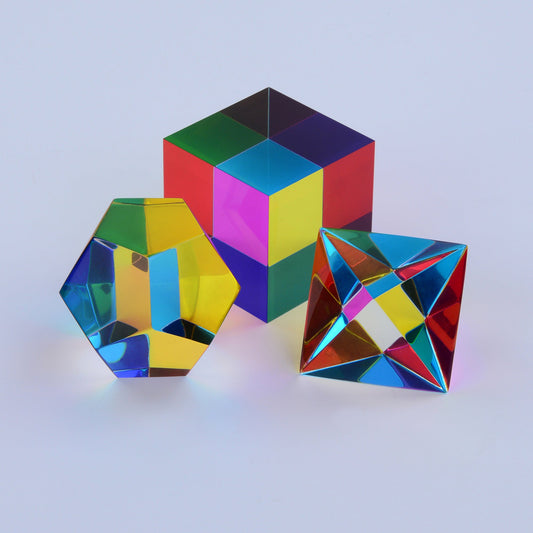 Three translucent CMY Platonic solids in sunlight, showing colours a dog would see as yellow and blue