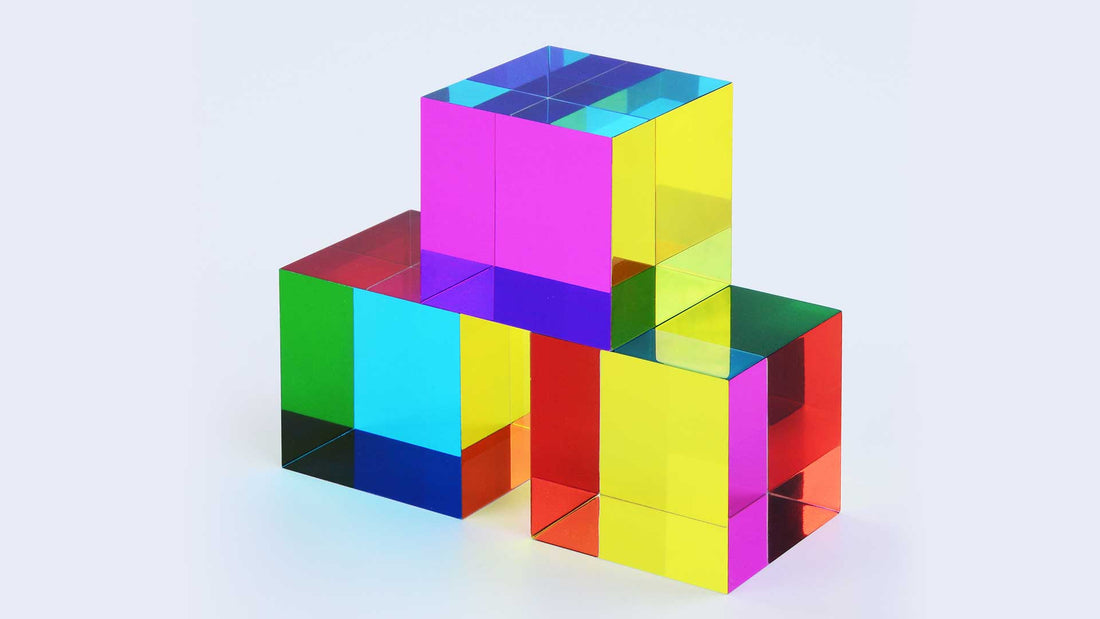 A CMY Cube held up to the light, used for colour therapy and calm focus
